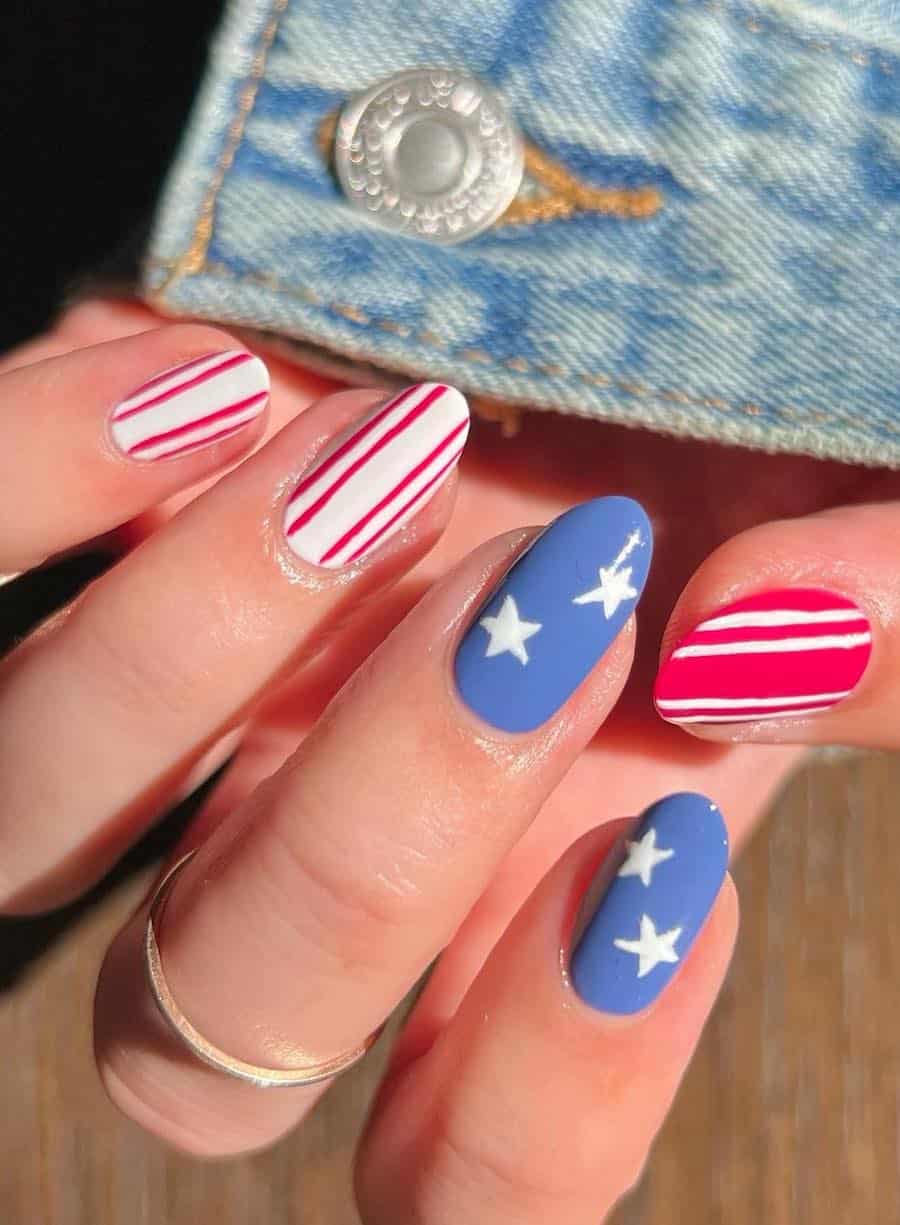 medium round nails with red and white stripe nail art and two blue accent nails with white stars