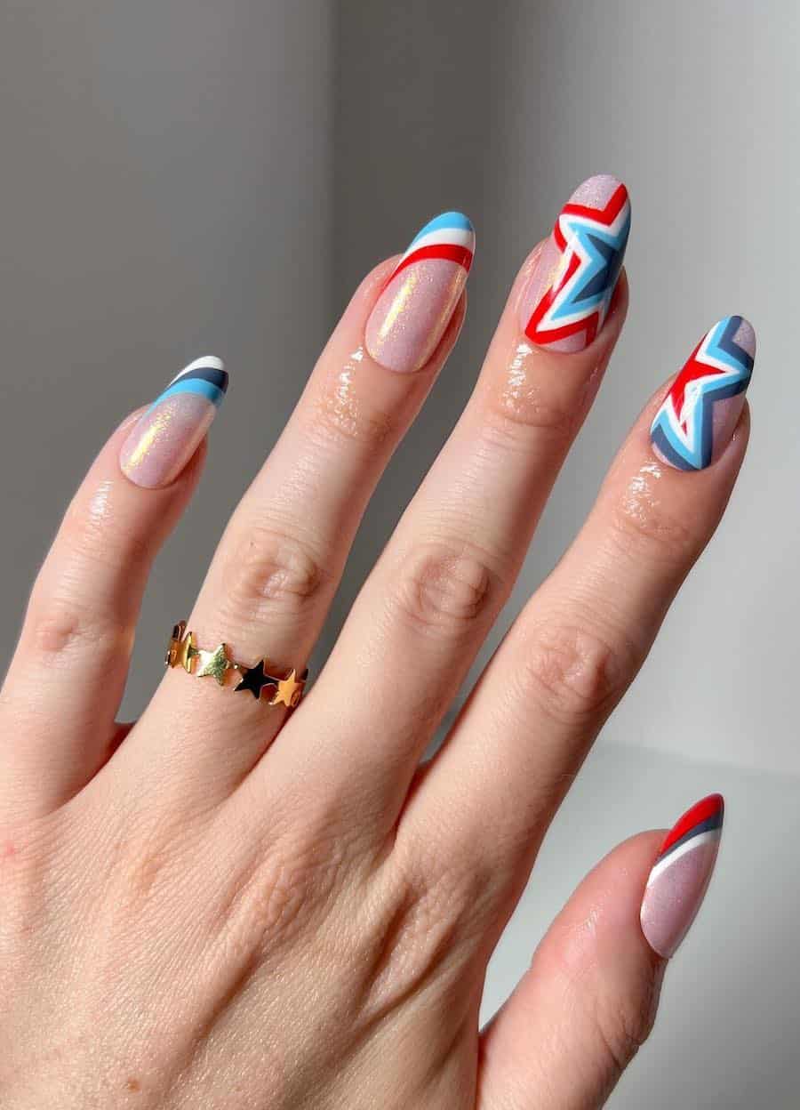 long round nails with shimmering pink polish and red, white, and blue striped French tips and star accent nails