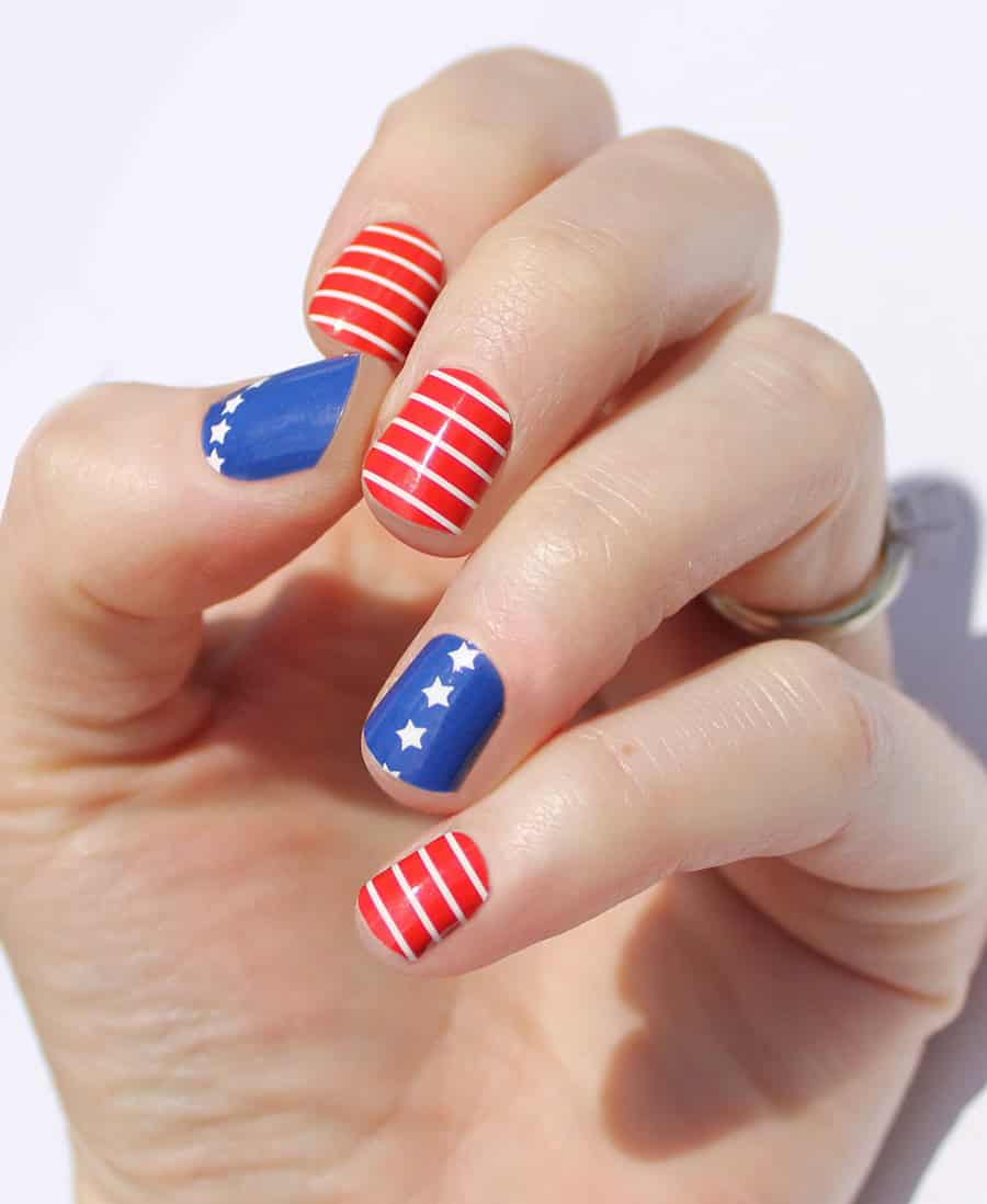 short nails with red and blue polish with white stars and stripes