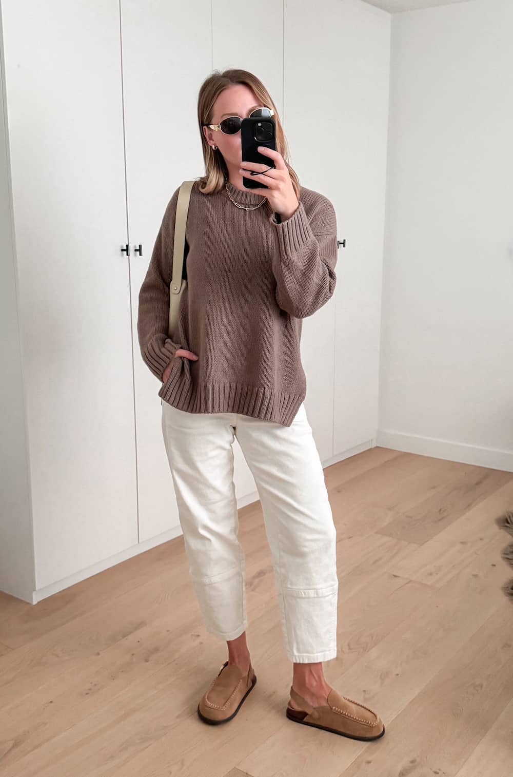 Christal wearing white cargo pants, a mauve sweater and Ugg flats.