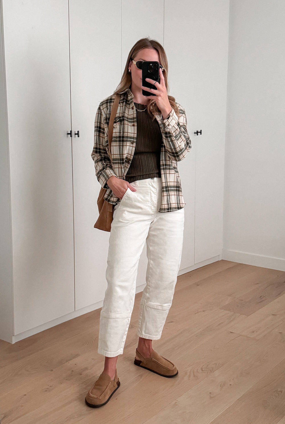 Christal wearing white cargo pants, a brown top and a flannel button down.