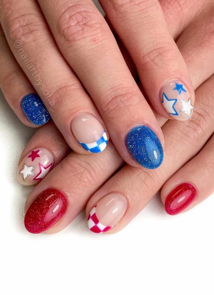 short round nails painted in red, white, and blue featuring checkerboard tips, sparkly polish, and star accents