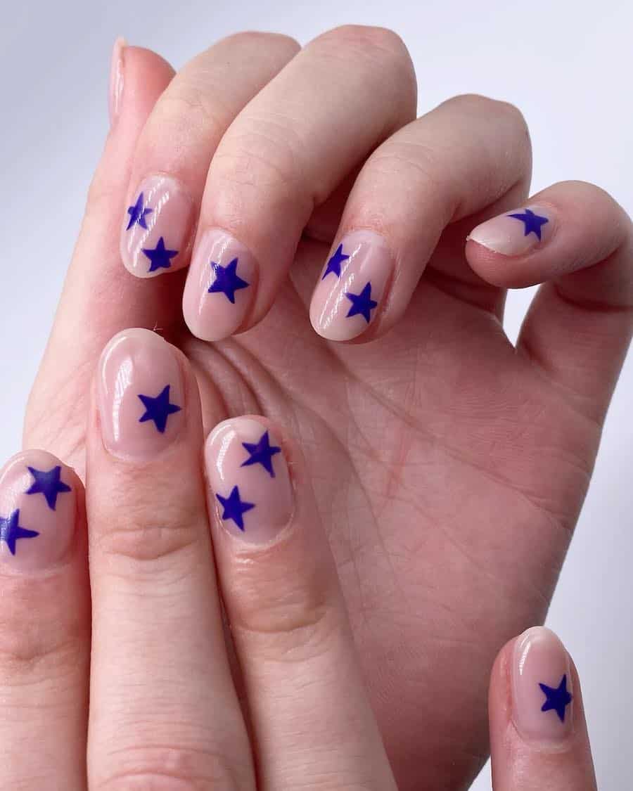 short round nude nails with bright blue stars