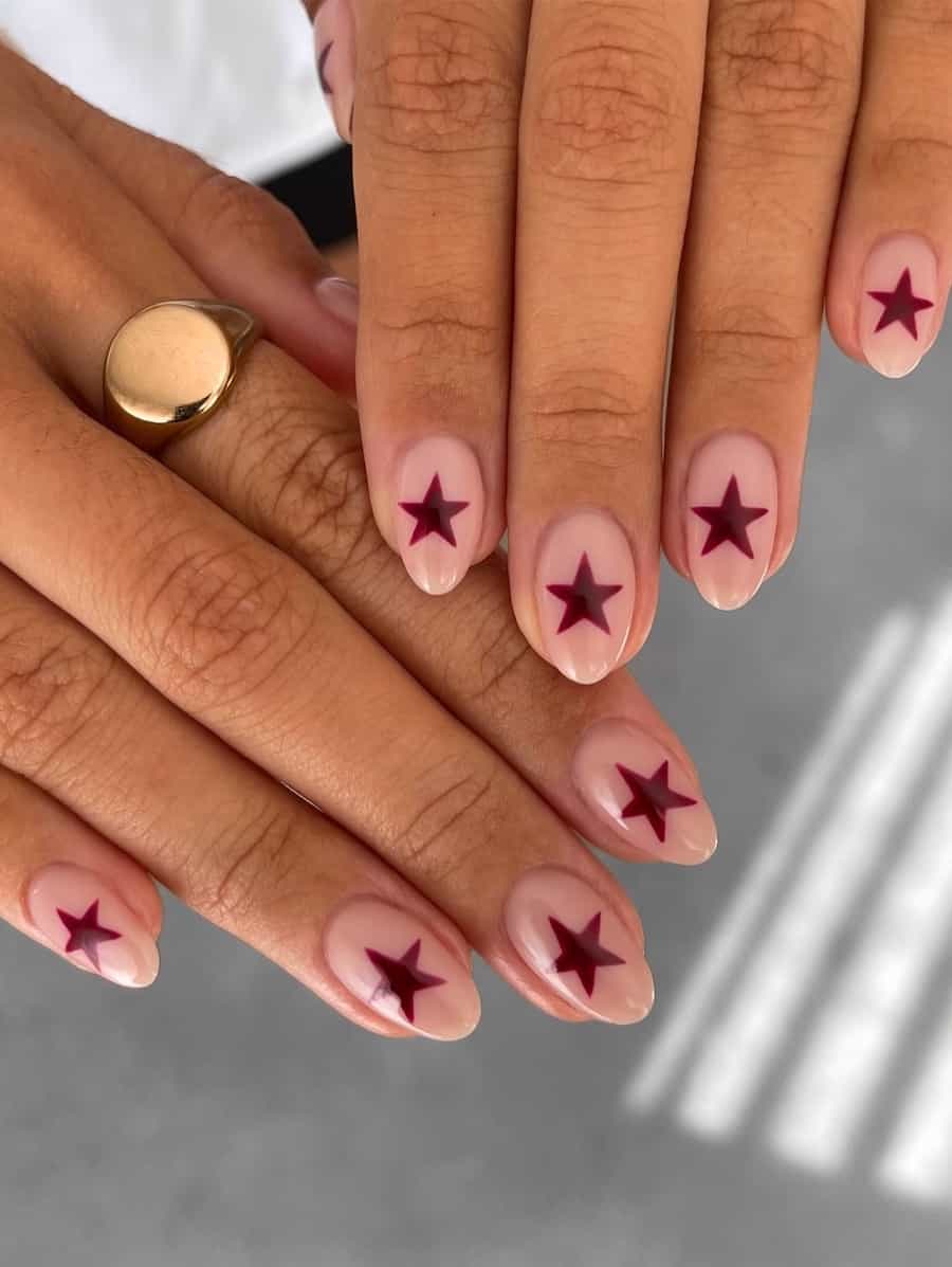 short nude almond nails with red stars