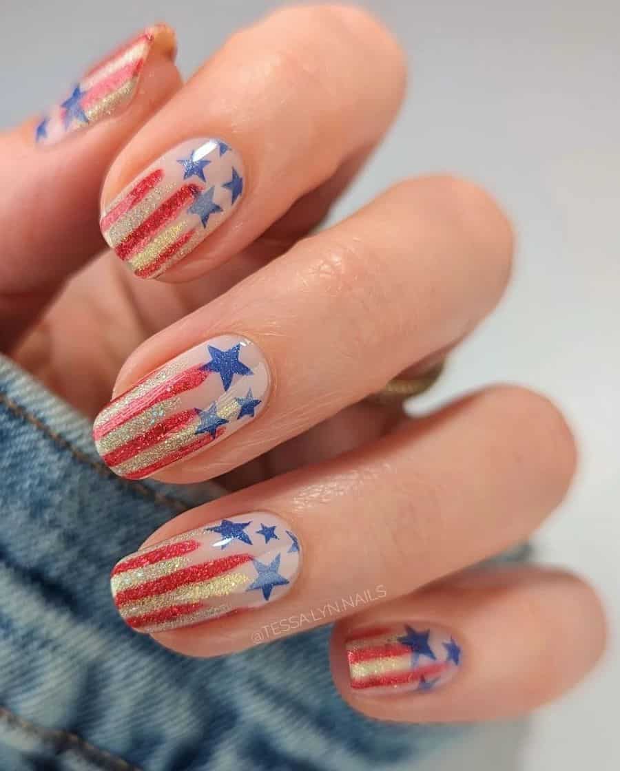 short squoval nails with gold, red, and blue glitter polish and a stars and stripes design