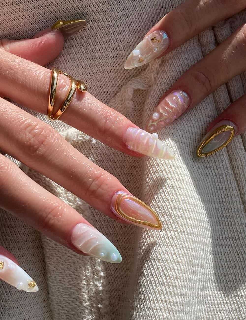 long almond nails with 3D ocean-inspired nail art with gold accents