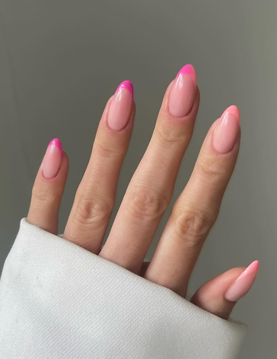 Medium nude almond nails with ombre pink to peach French tips
