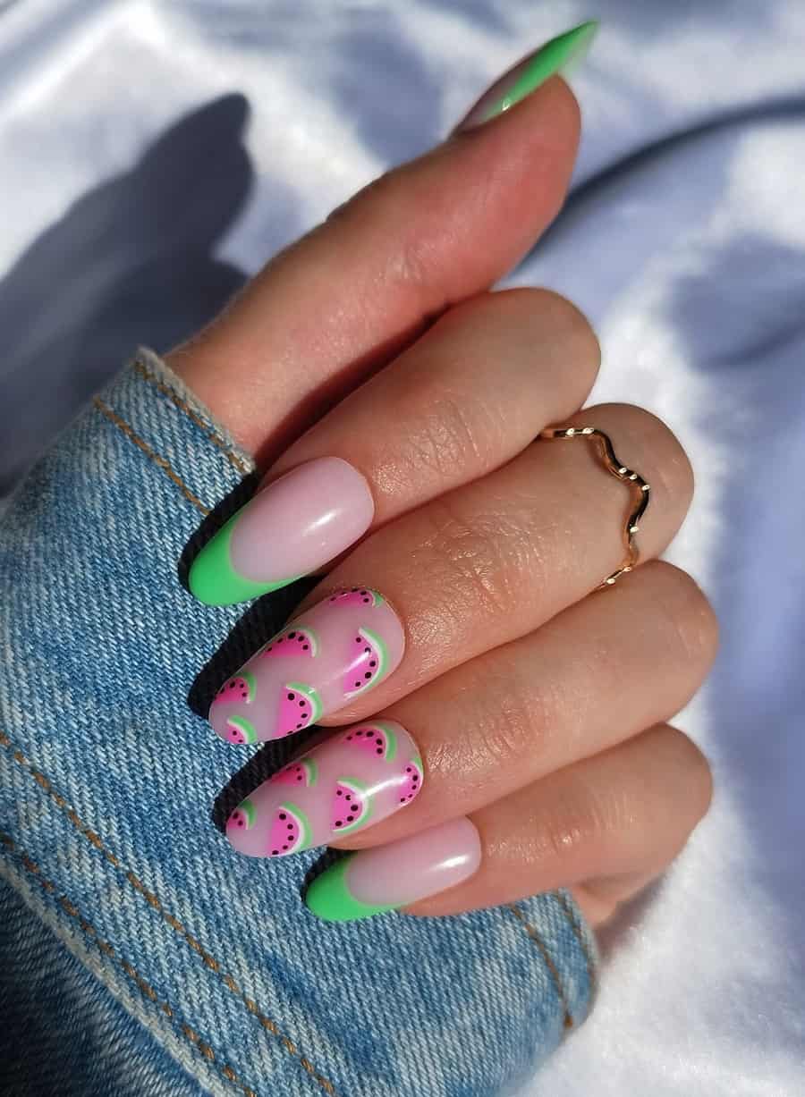 Long nude pink almond nails with spring green French tips and two accent nails featuring watermelon nail art