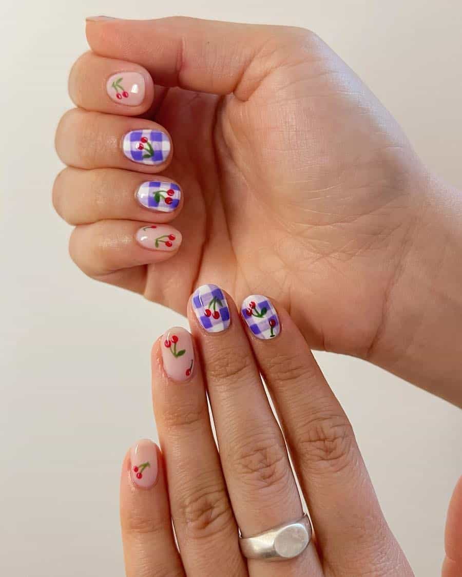 Short nude nails with cherry nail art and accent nails featuring purple gingham
