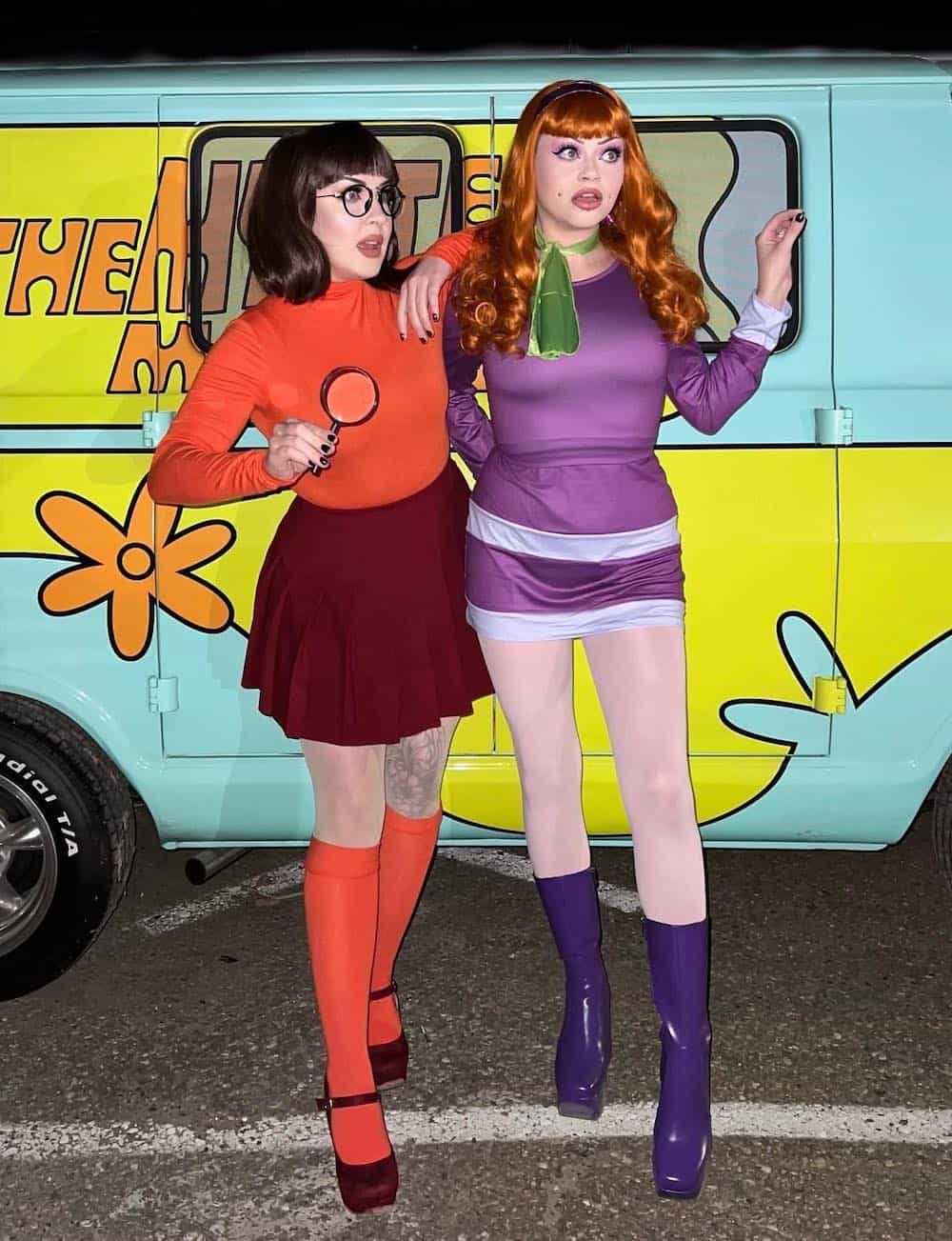 Two women dress up as Velma and Daphne from Scooby Doo on Halloween.