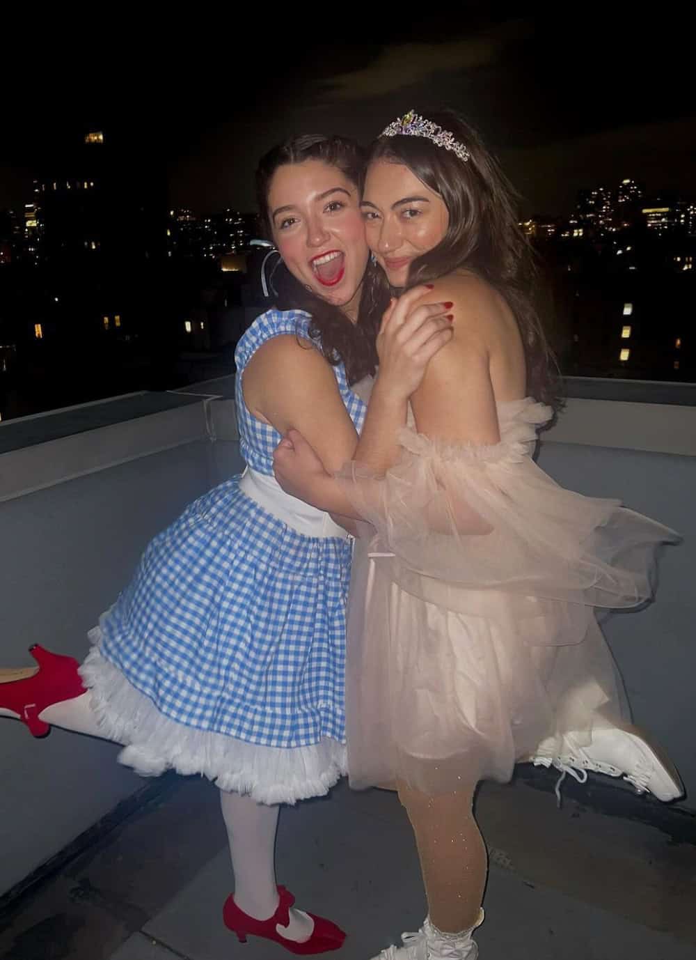Two women dressed up as Dorothy and Glenda the Good Witch from The Wizard of Oz on Halloween.