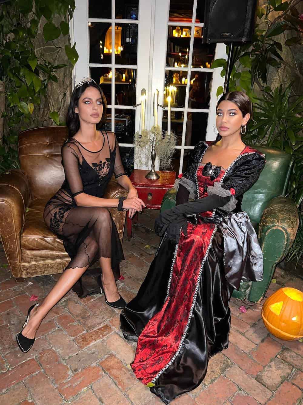 Two women dressed up as vampires on Halloween.
