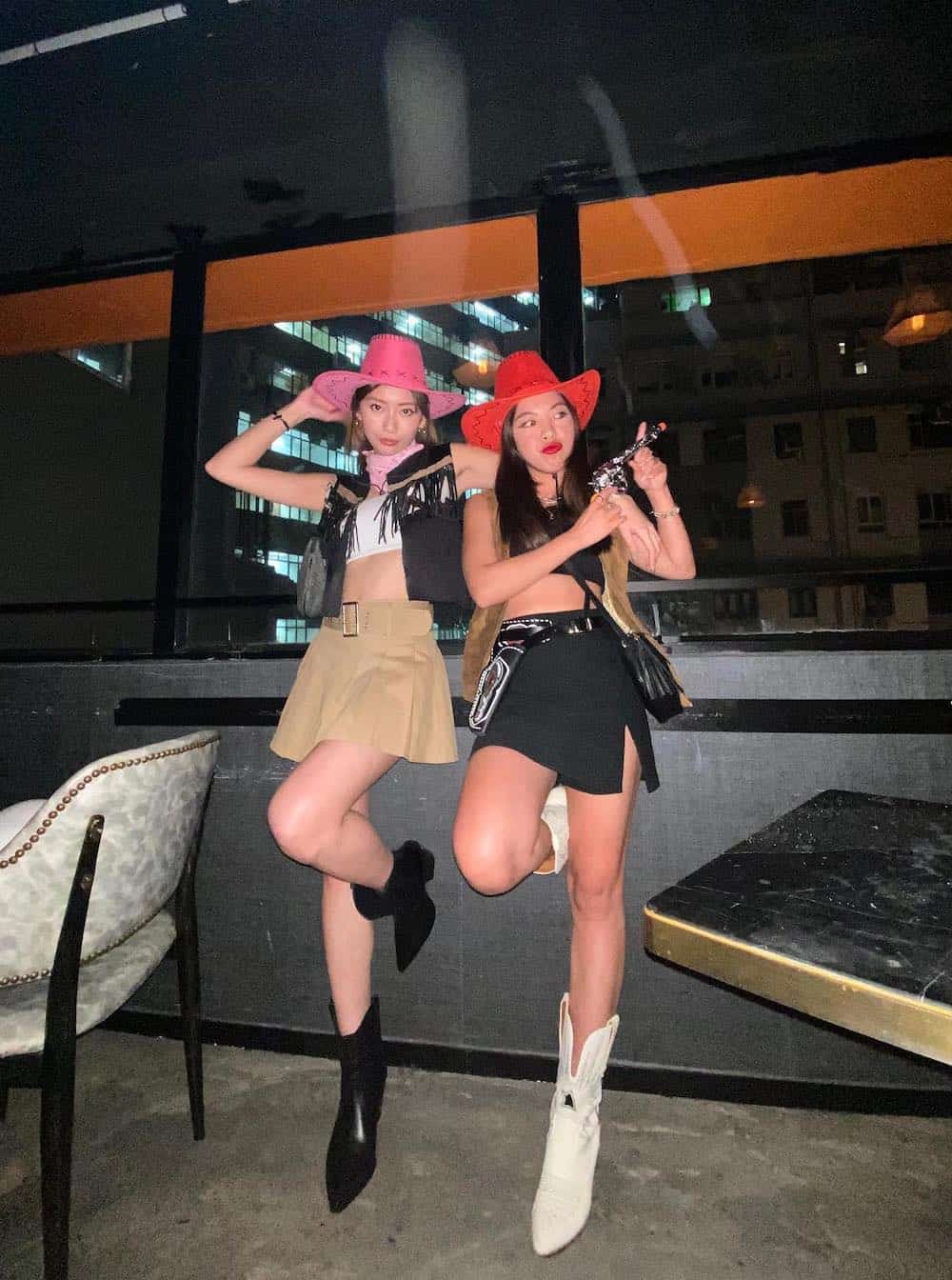 Two women dressed up as cowgirls on Halloween.