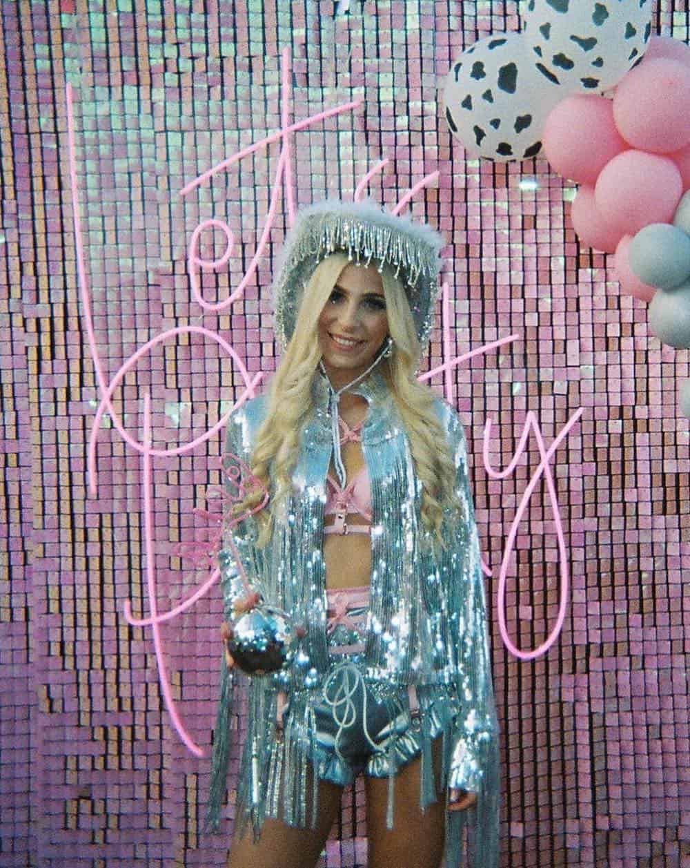 a woman dressed as a disco cowgirl