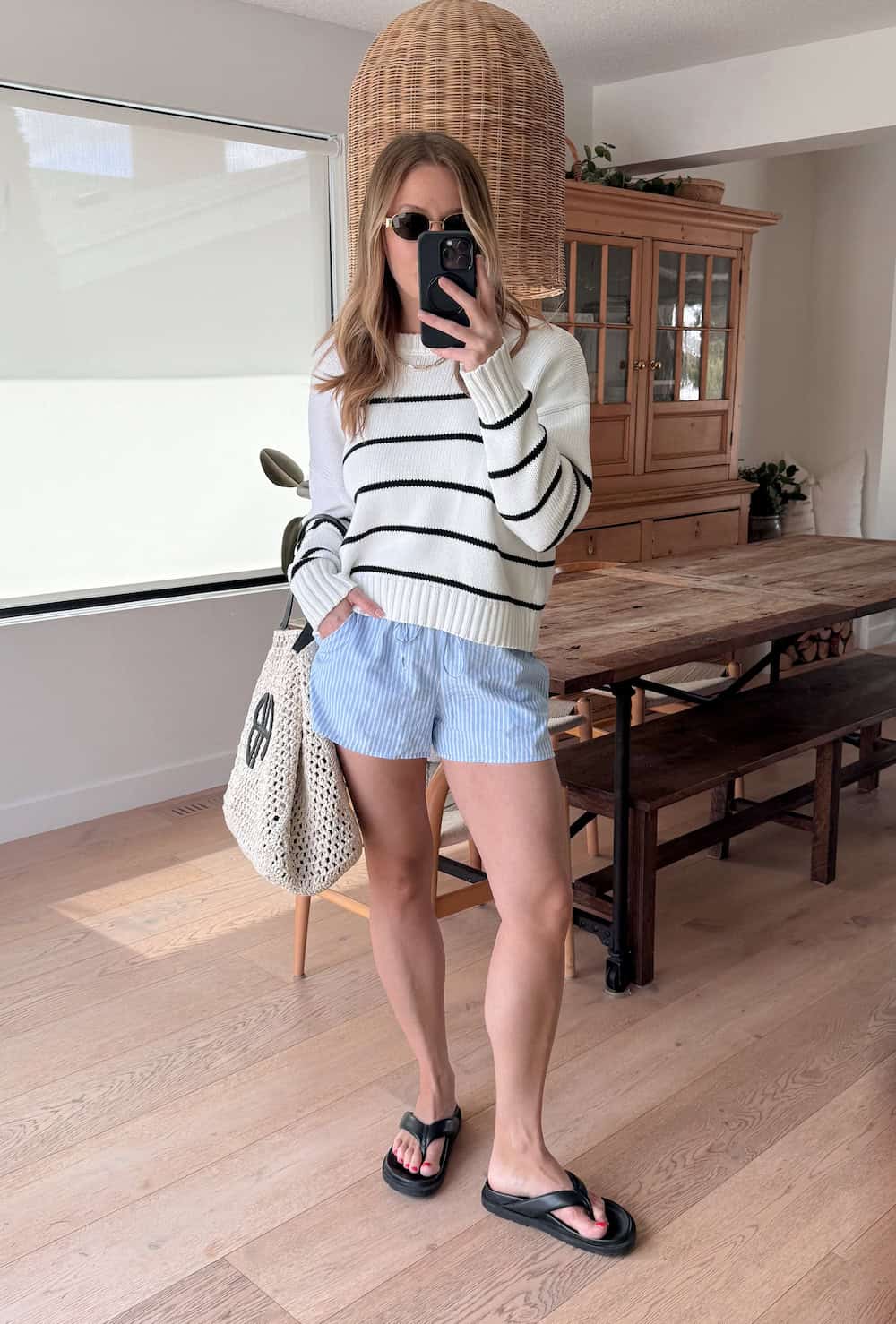 Christal wearing white and blue striped shorts with a white and black striped sweater.