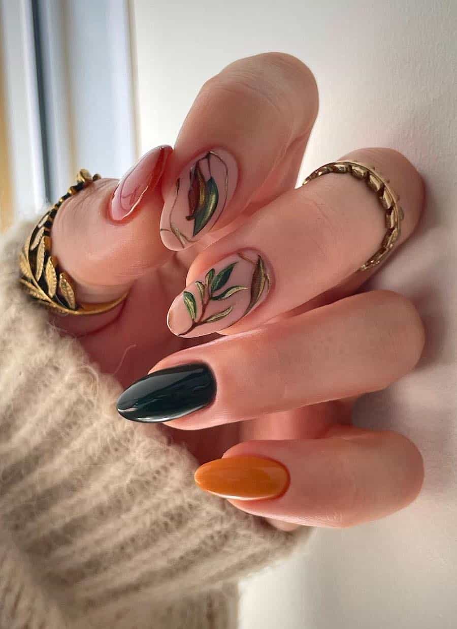 medium almond nails featuring gradient fall shades and two matte nude accent nails with fall botanical nail art