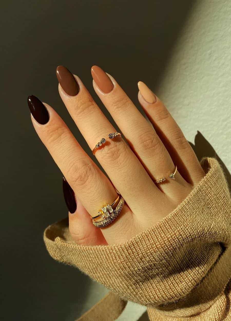 beige to black gradient nail design on medium almond nails