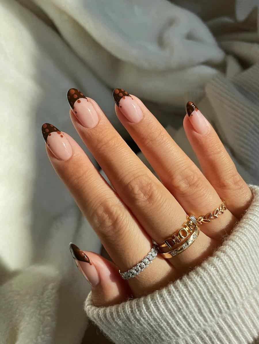 medium nude almond nails with brown tips and light brown dot accents
