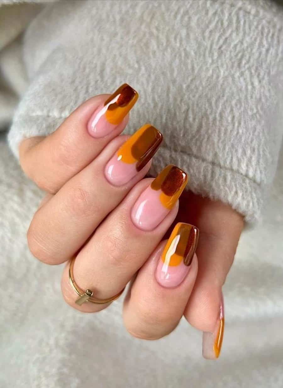 long nude pink square nails with orange, brown, and metallic red swatches on the tips
