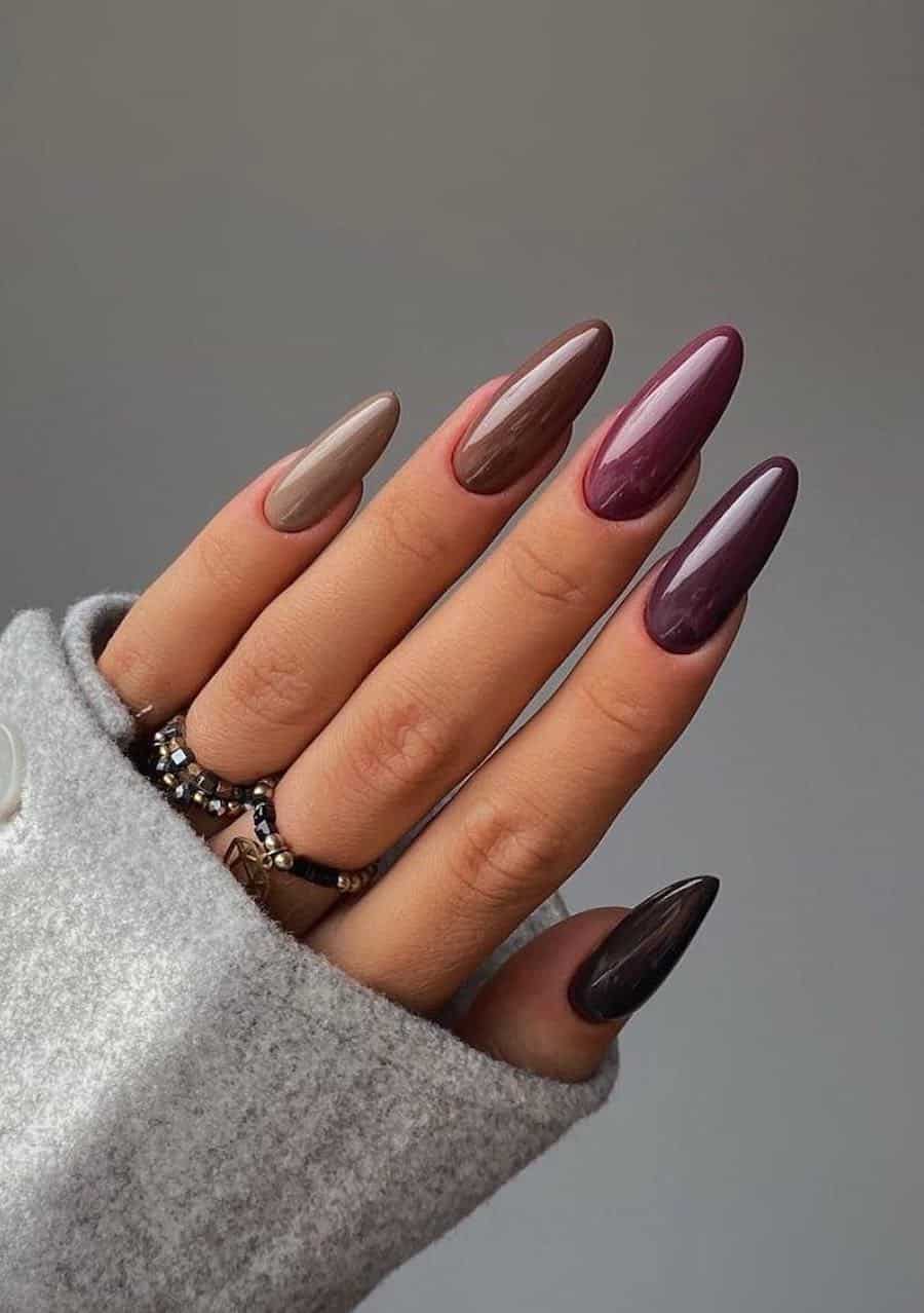 long almond nails featuring a gradient with plum, brown, mocha, and other fall shades