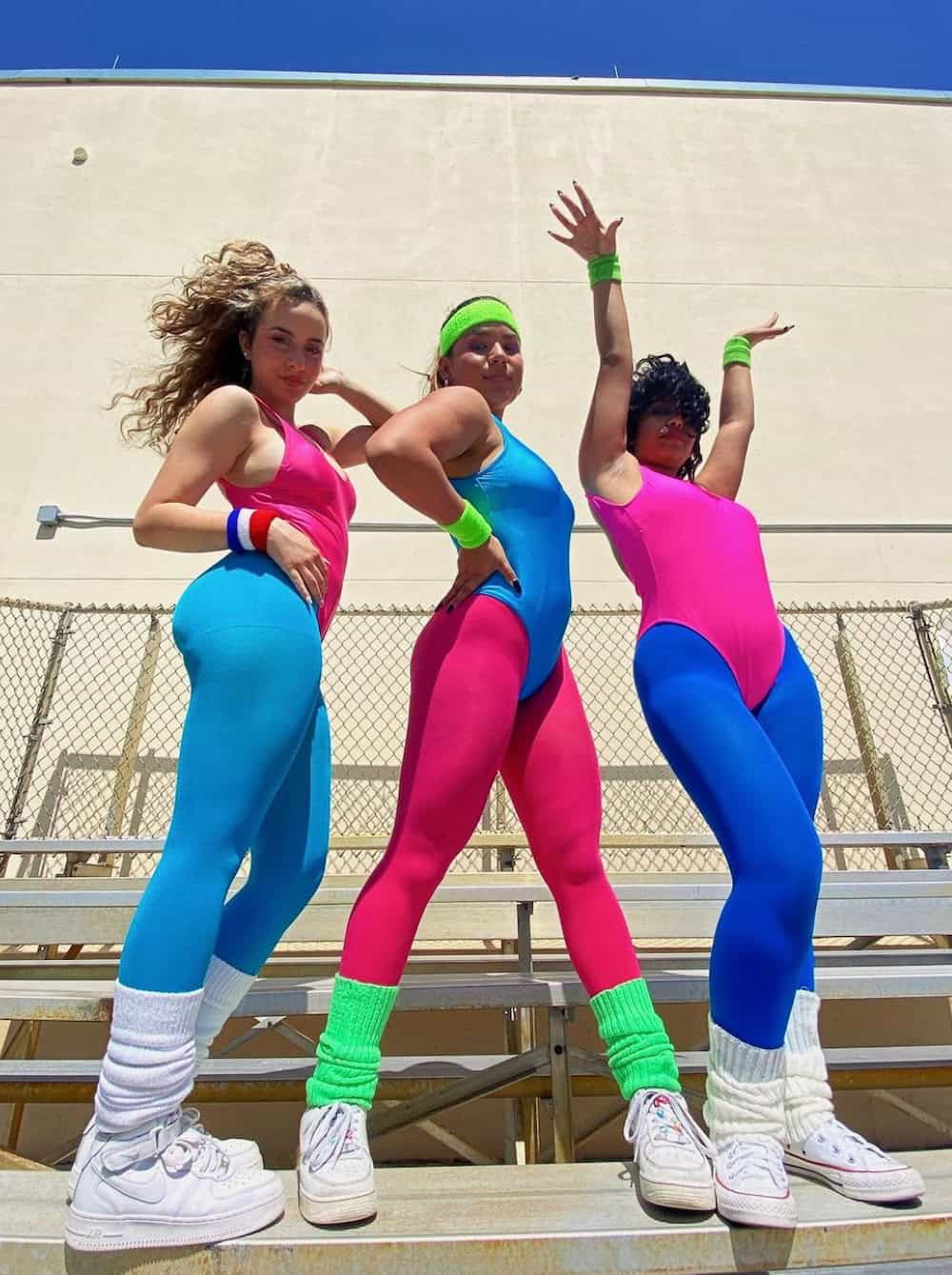 Three women dressed as 80s aerobics girls for Halloween.