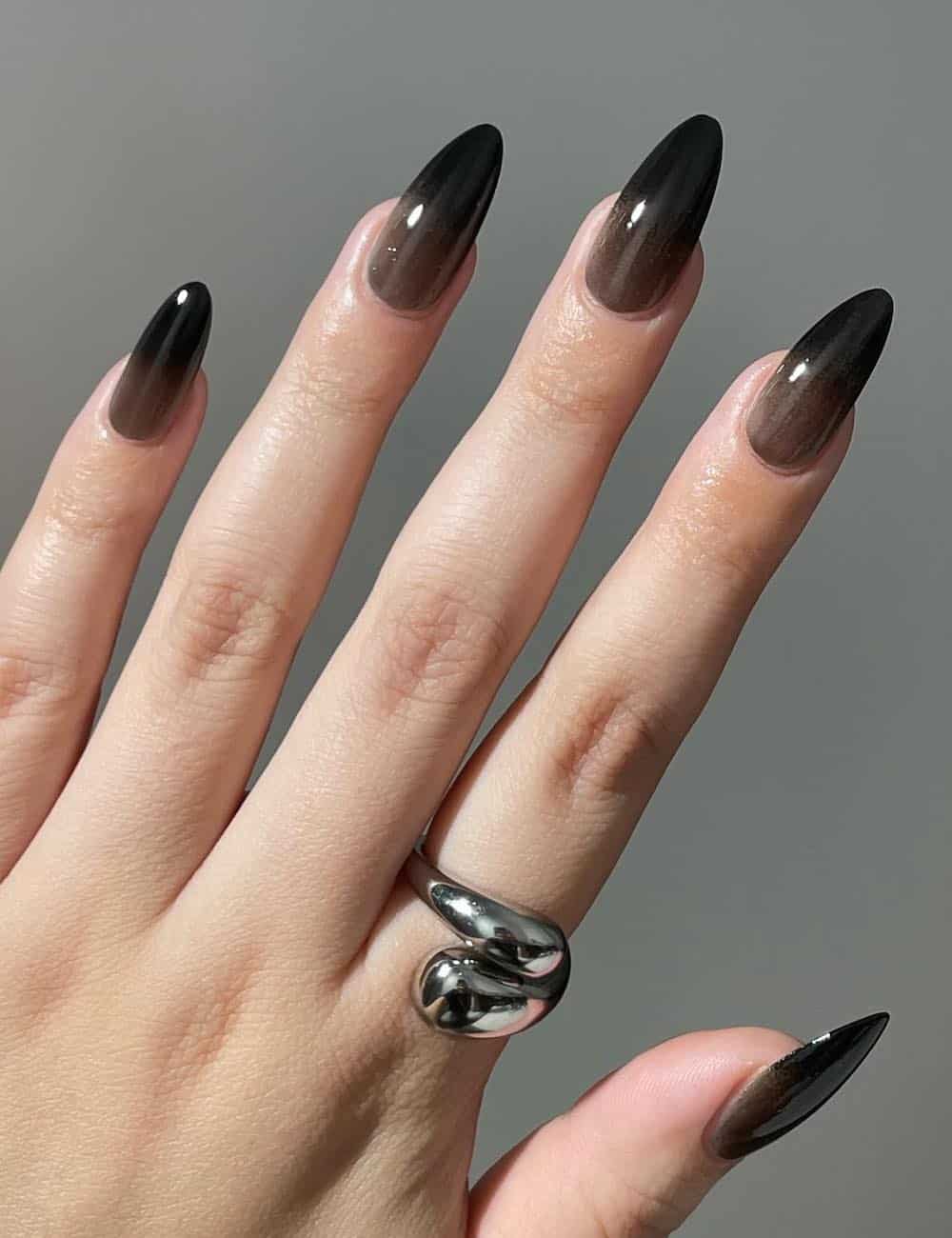 long almond nails with sheer to opaque ombre black nails