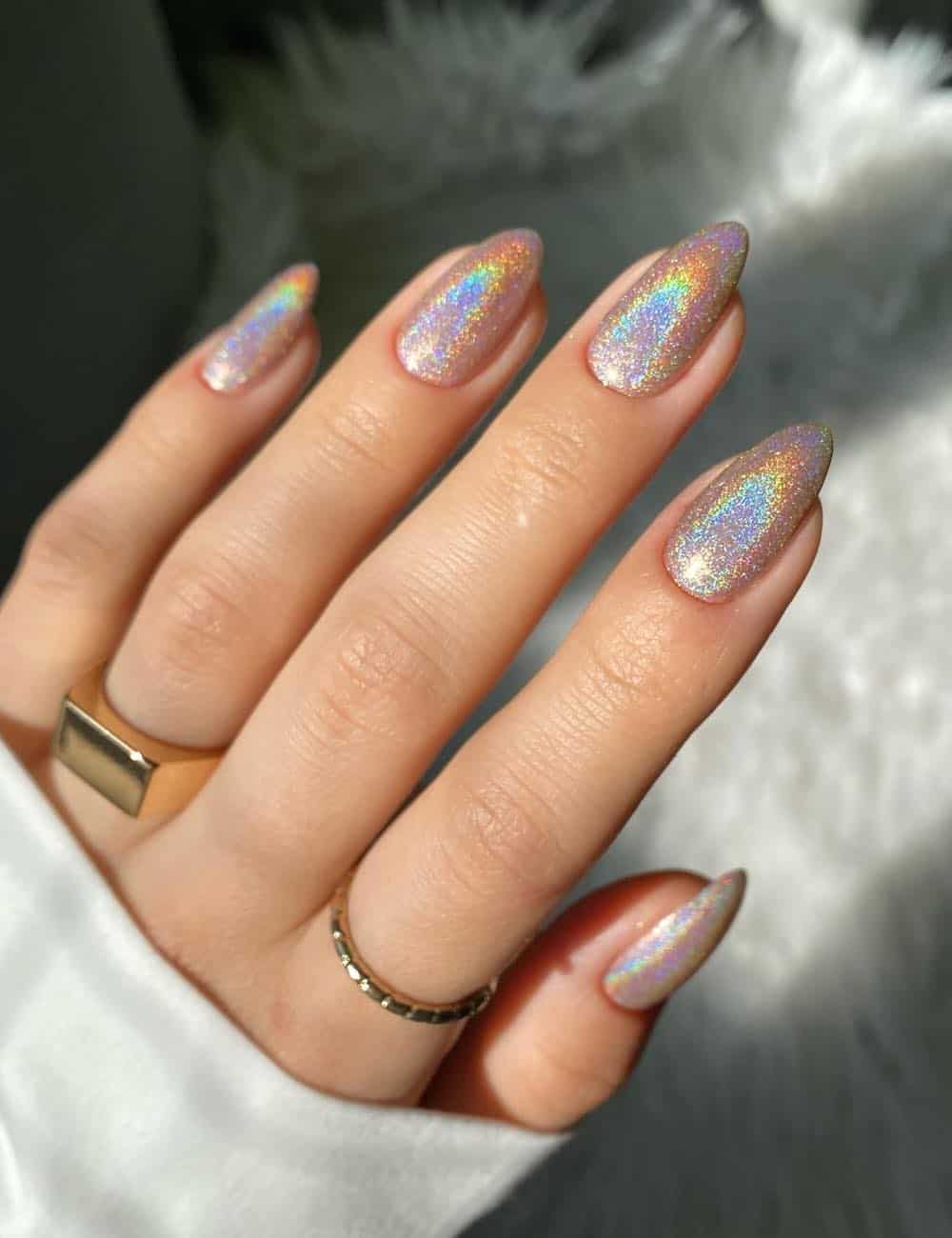 short almond nails with shimmering iridescent nail polish
