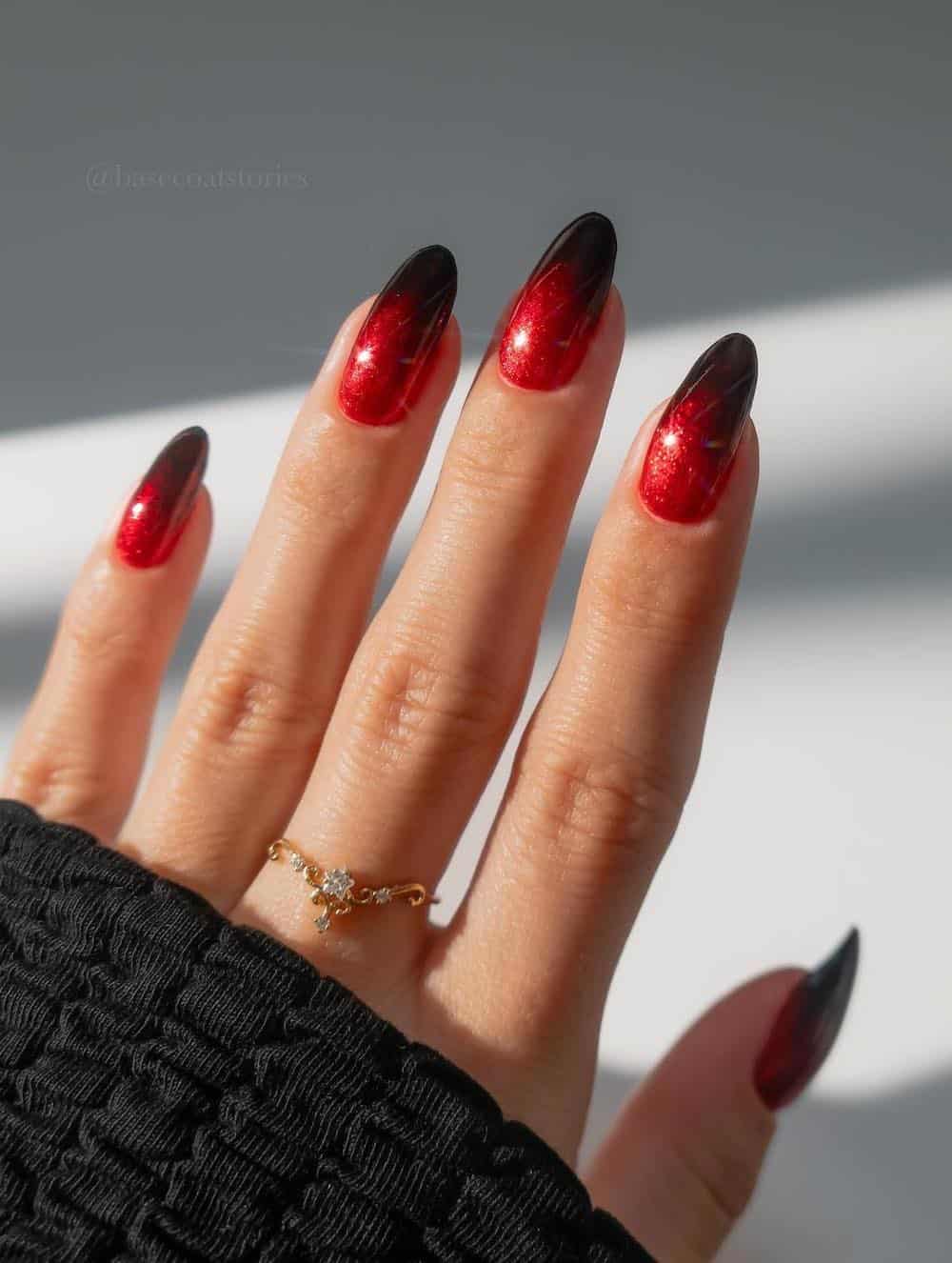 medium almond nails with a sparkly red and black ombre