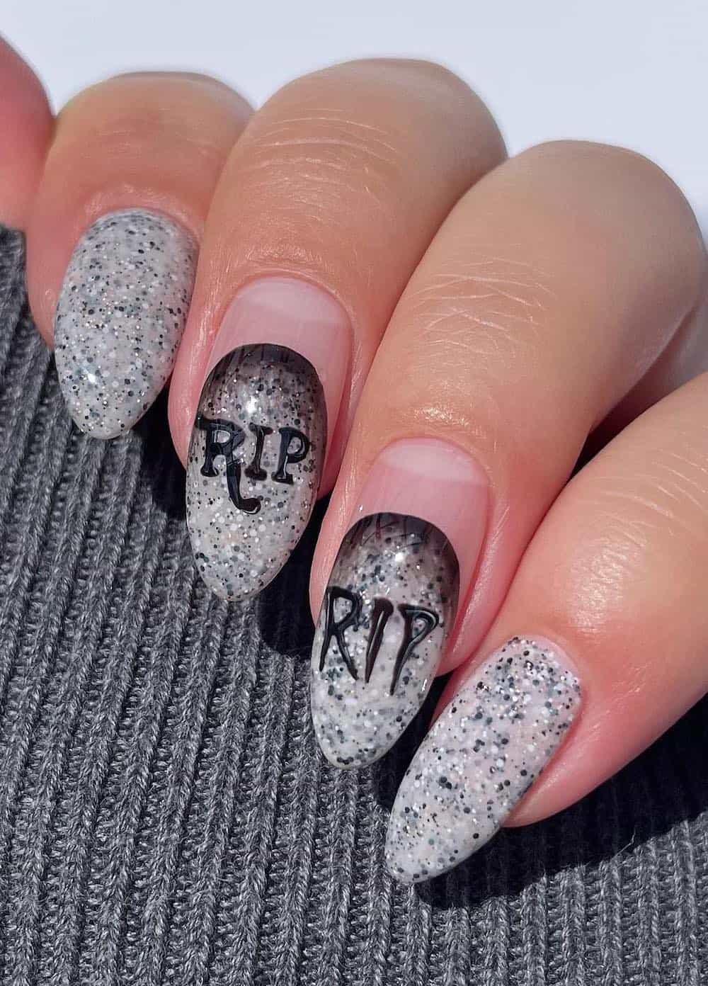 long speckled neutral almond nails with tombstone nail art