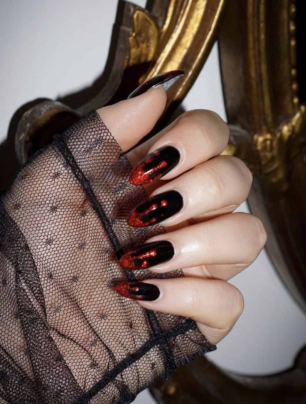 long black almond nails with glittering red dripping tips