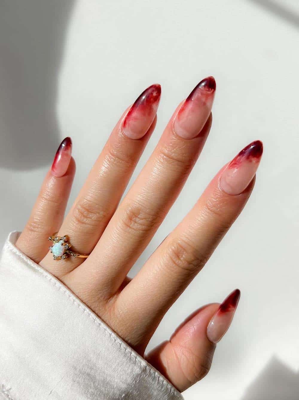 long nude almond nails with blood red tips