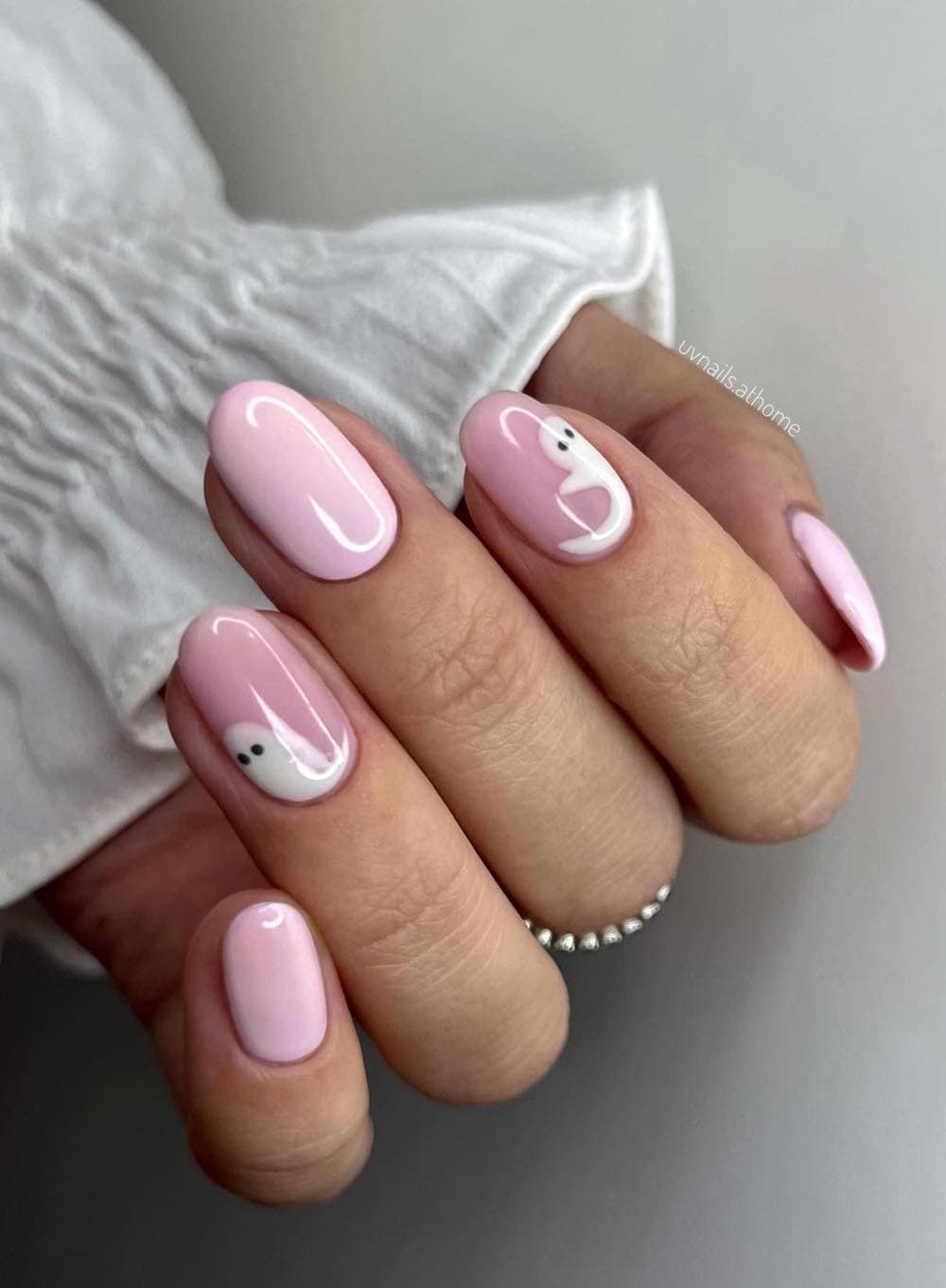 short pink round nails with white ghost nail art