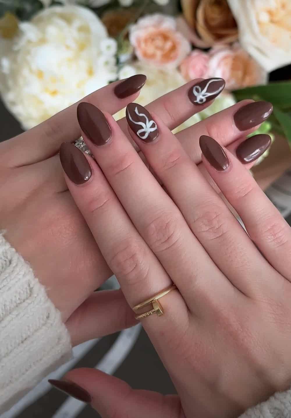 short brown nails with white bow accents