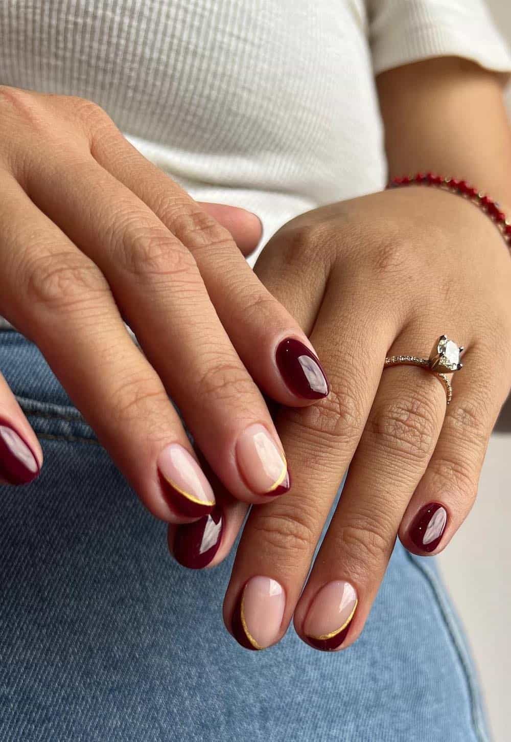 short nude and brown nails with brown tips and gold accents