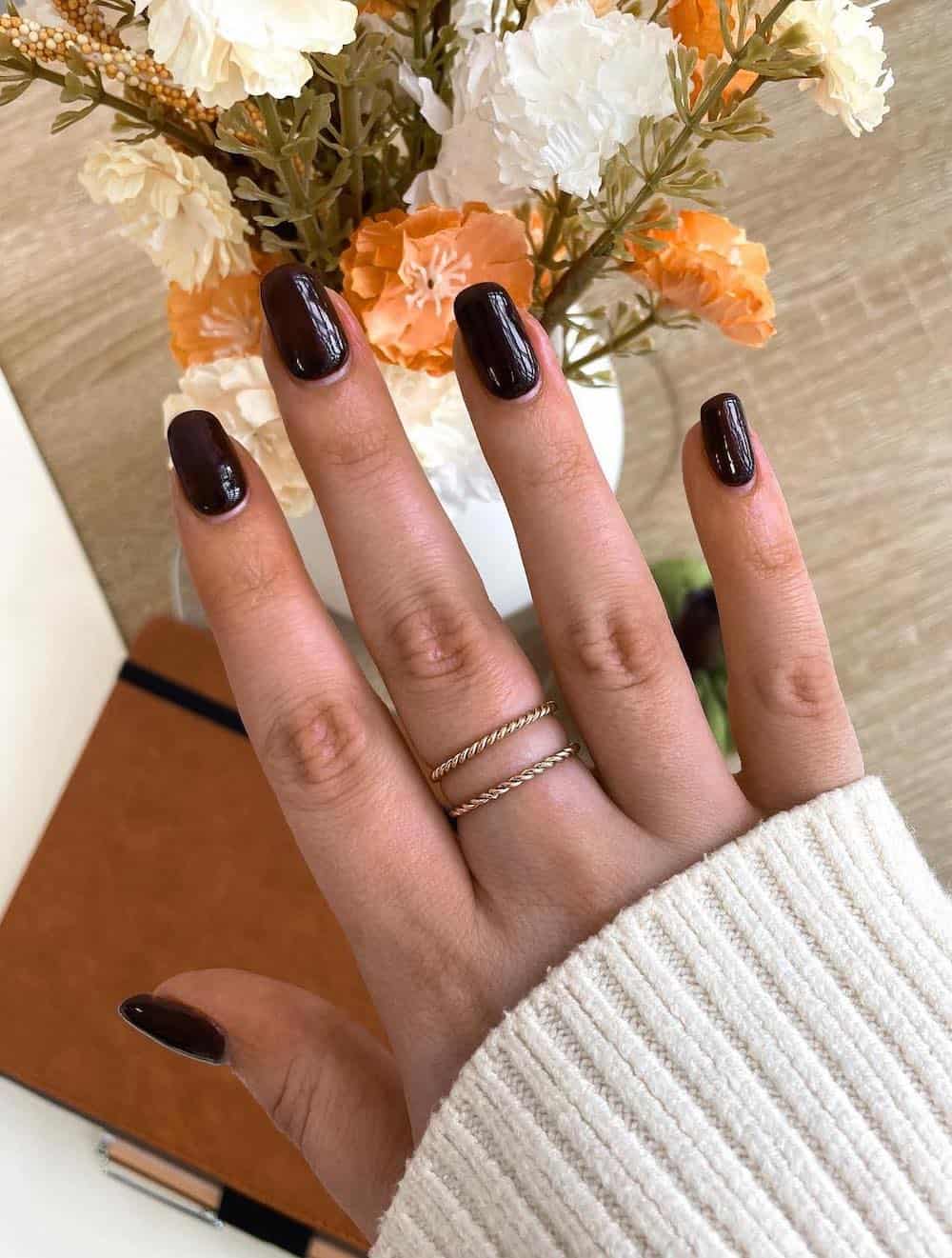 short squoval nails with dark brown polish