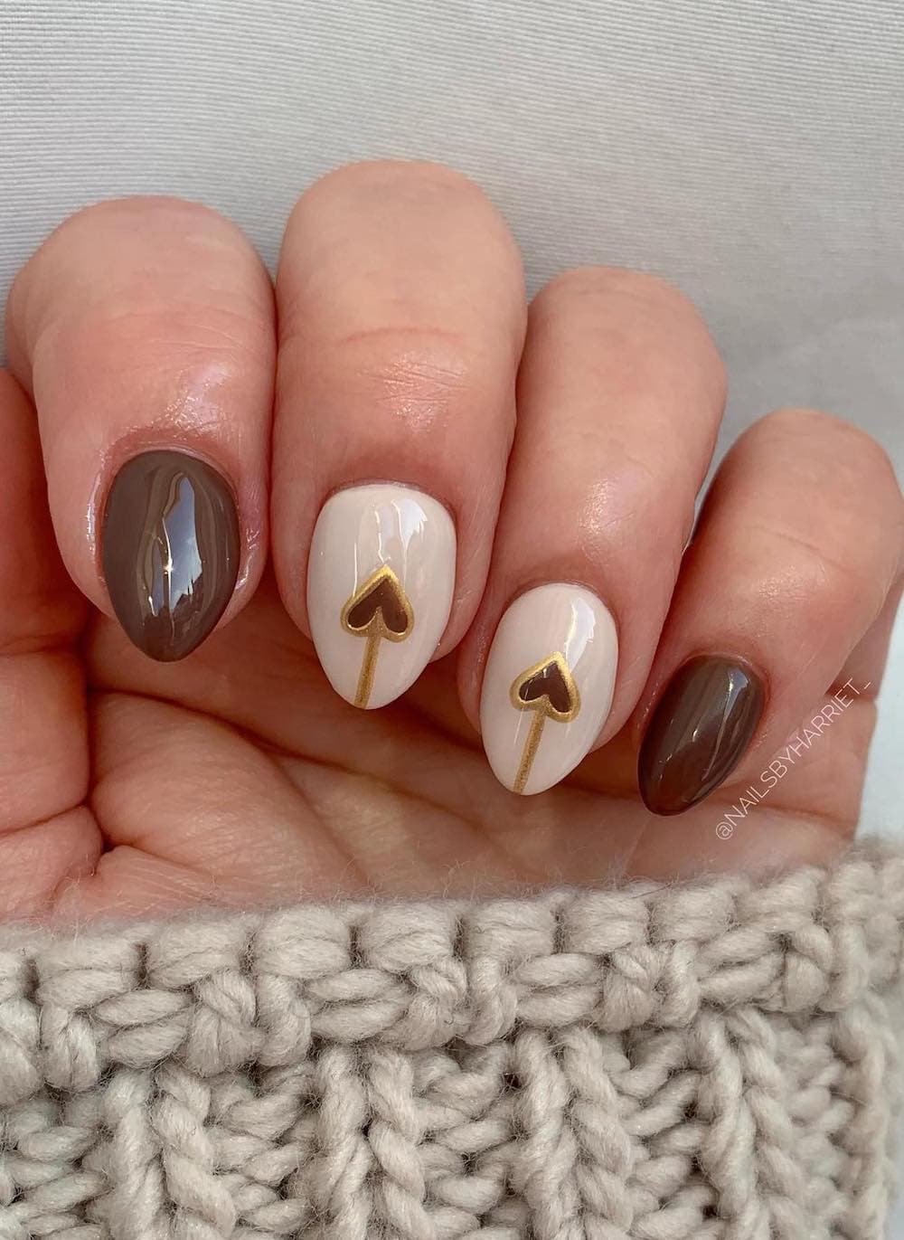 short cream and brown nails with heart accents and gold details