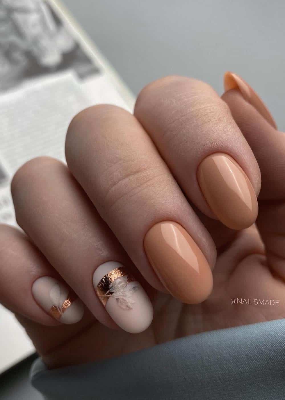 short beige nails with matte nude accent nails featuring botanical art and gold foil