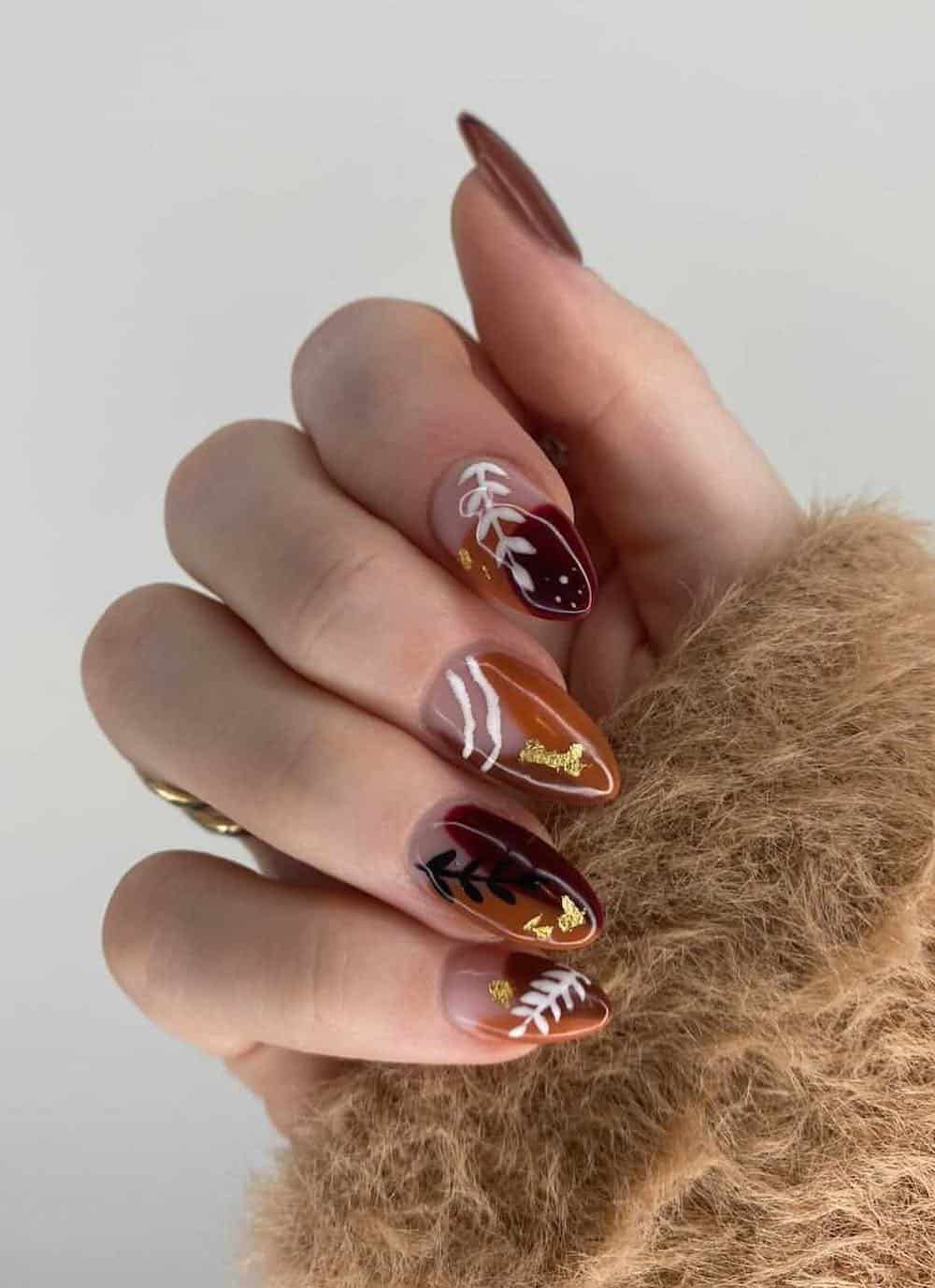 brown and camel nails with boho style art and gold foil