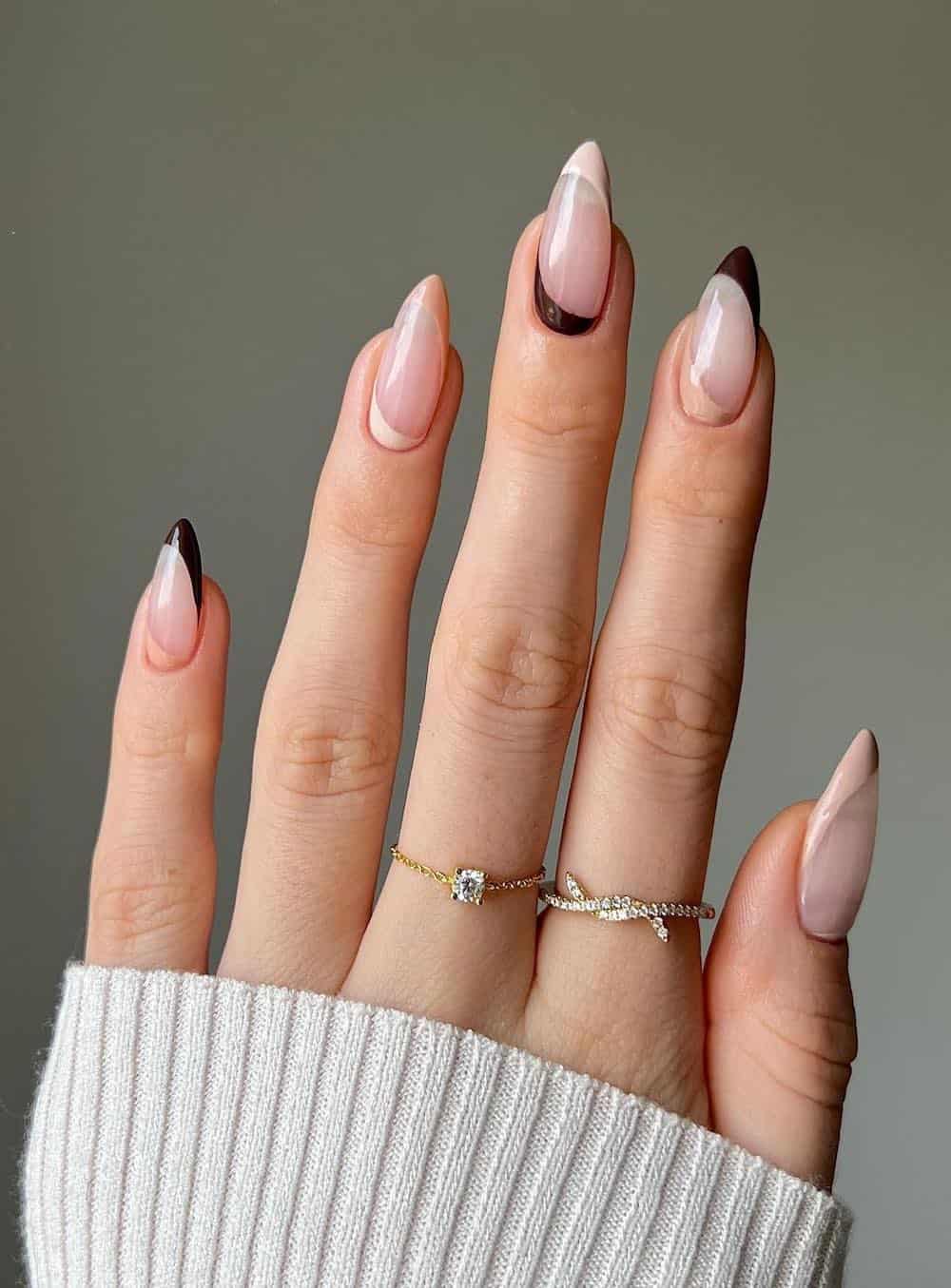 nude almond nails with brown and beige french tips and reverse french tips