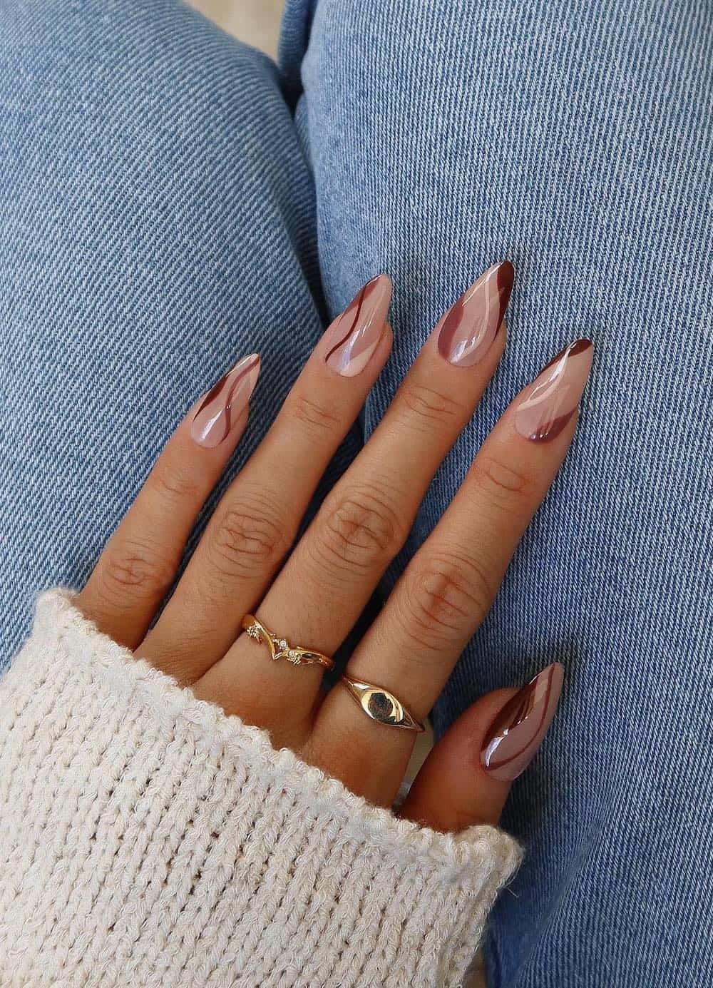 long nude almond nails with brown and cream waves