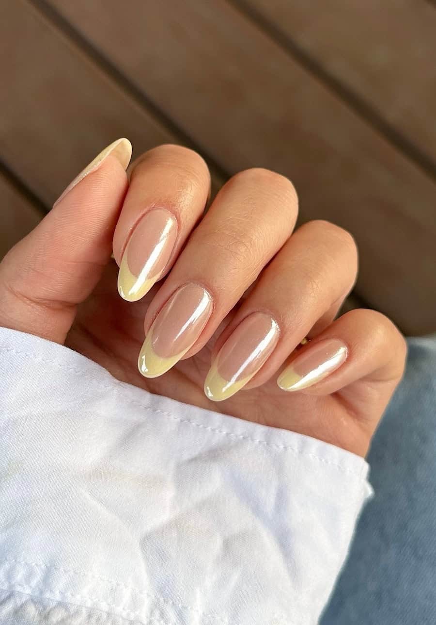 yellow tips on nude nails with chrome finish