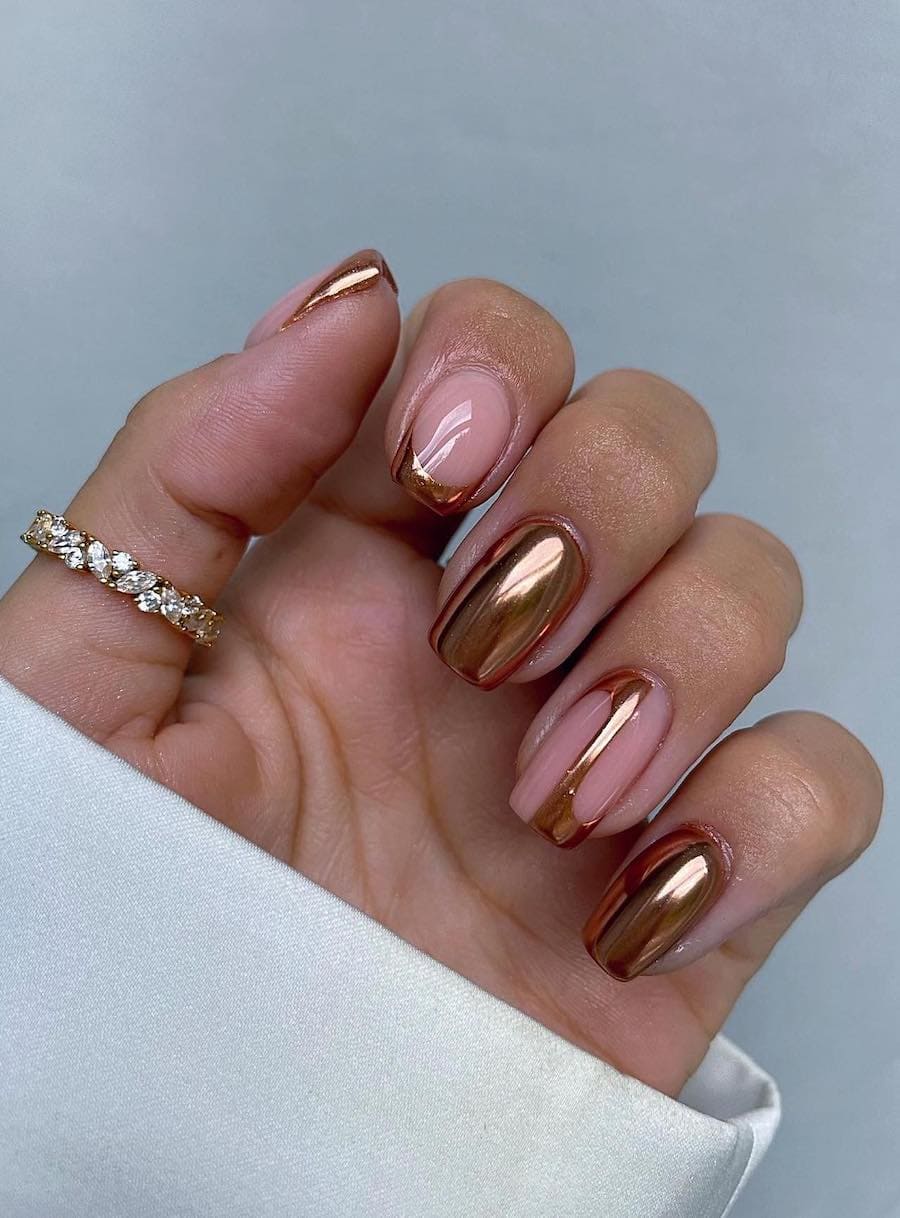 gold chrome nails with nude accents