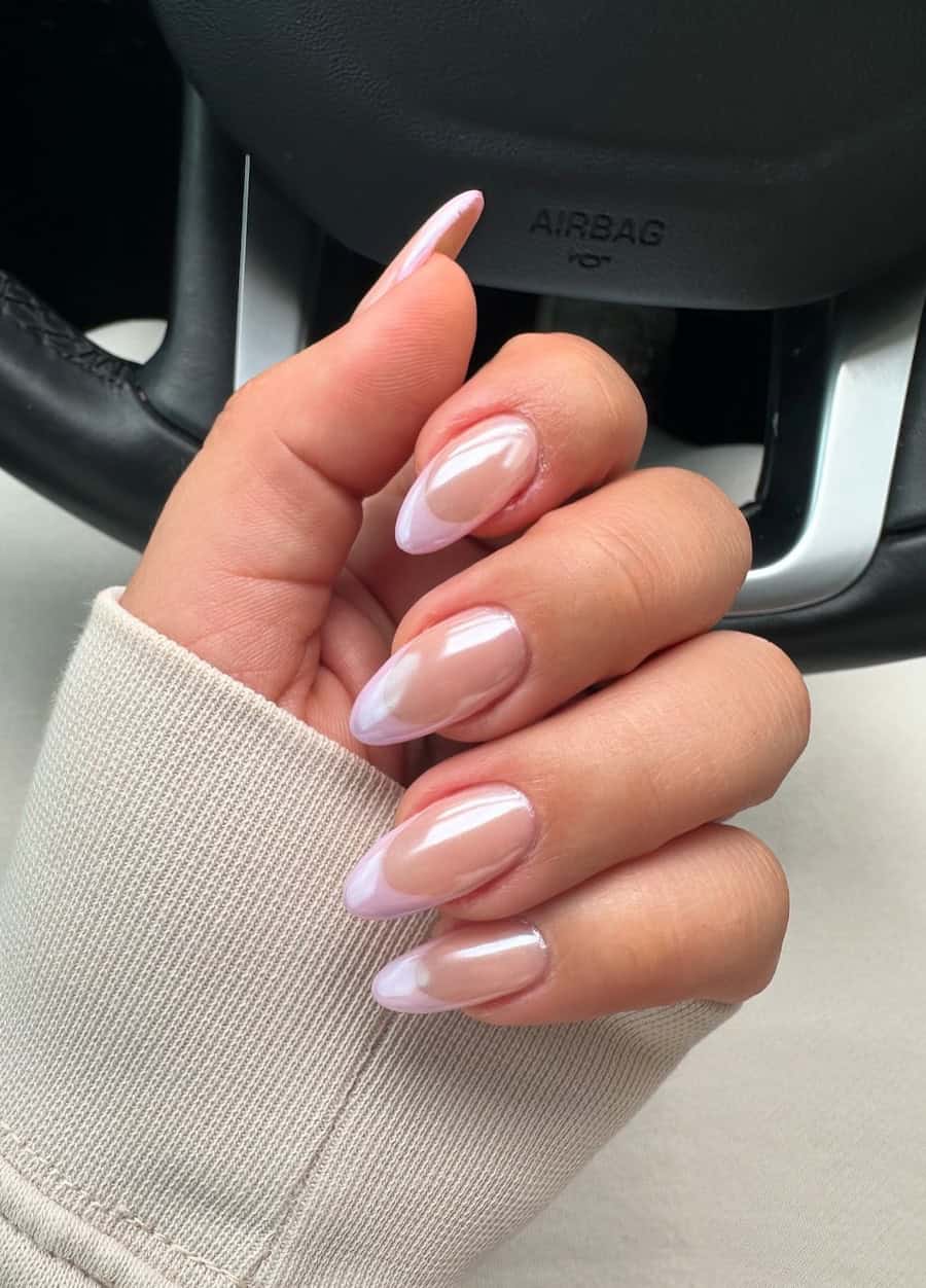 nude almond nails with pink tips and a chrome finish