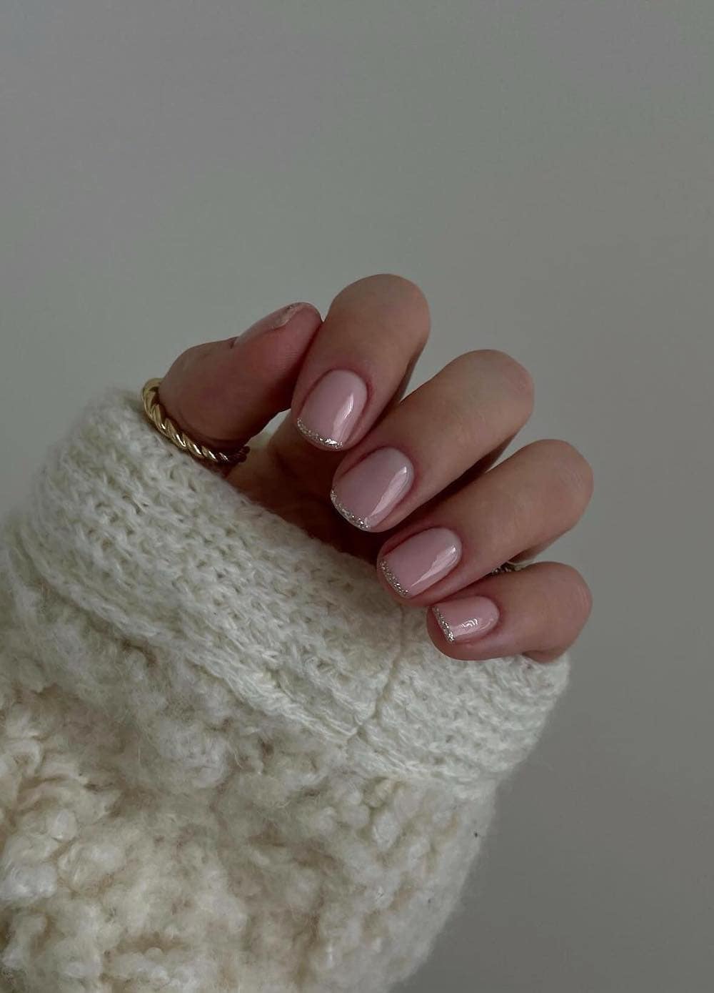 short nude pink nails with silver glitter tips