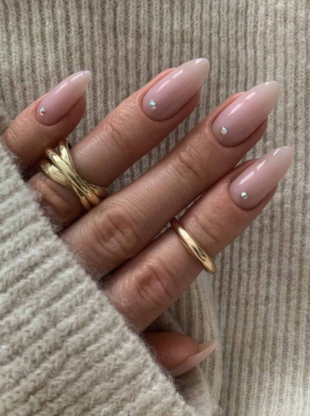 long milky pink almond nails with gem details