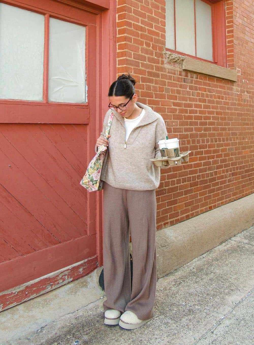 Woman wearing sweat pants with a quarterzip and Uggs.