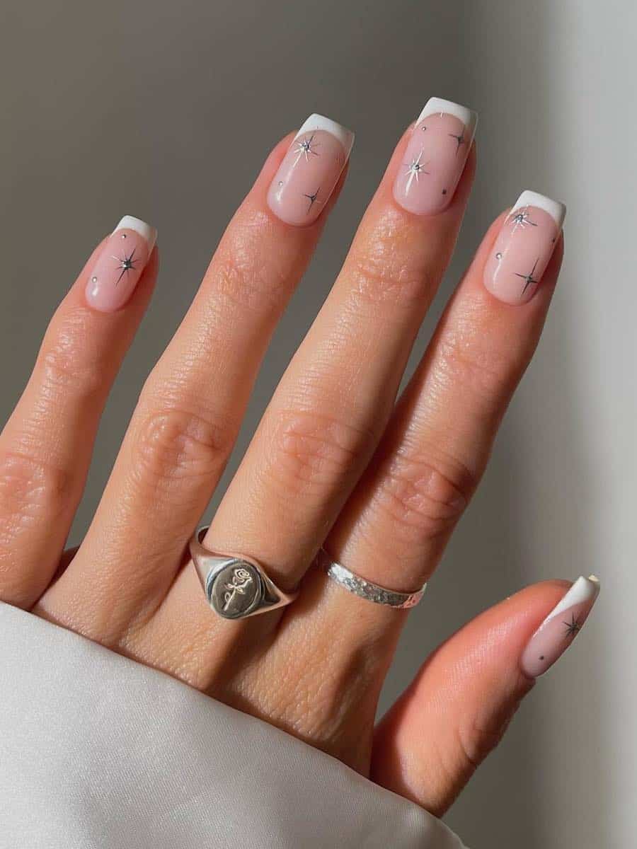 French manicure on short nails with silver star accents