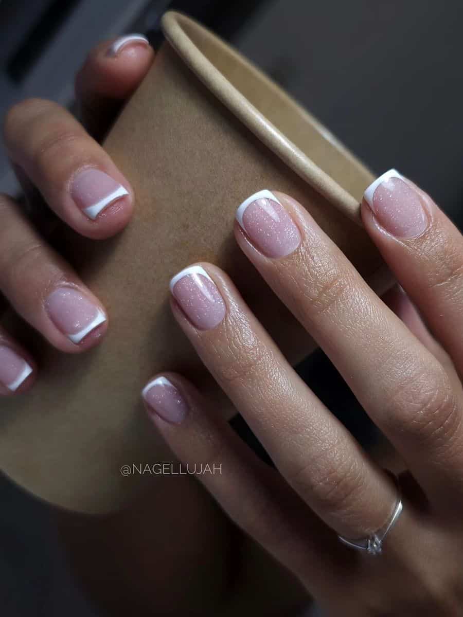 short French tip nails with white speckled details