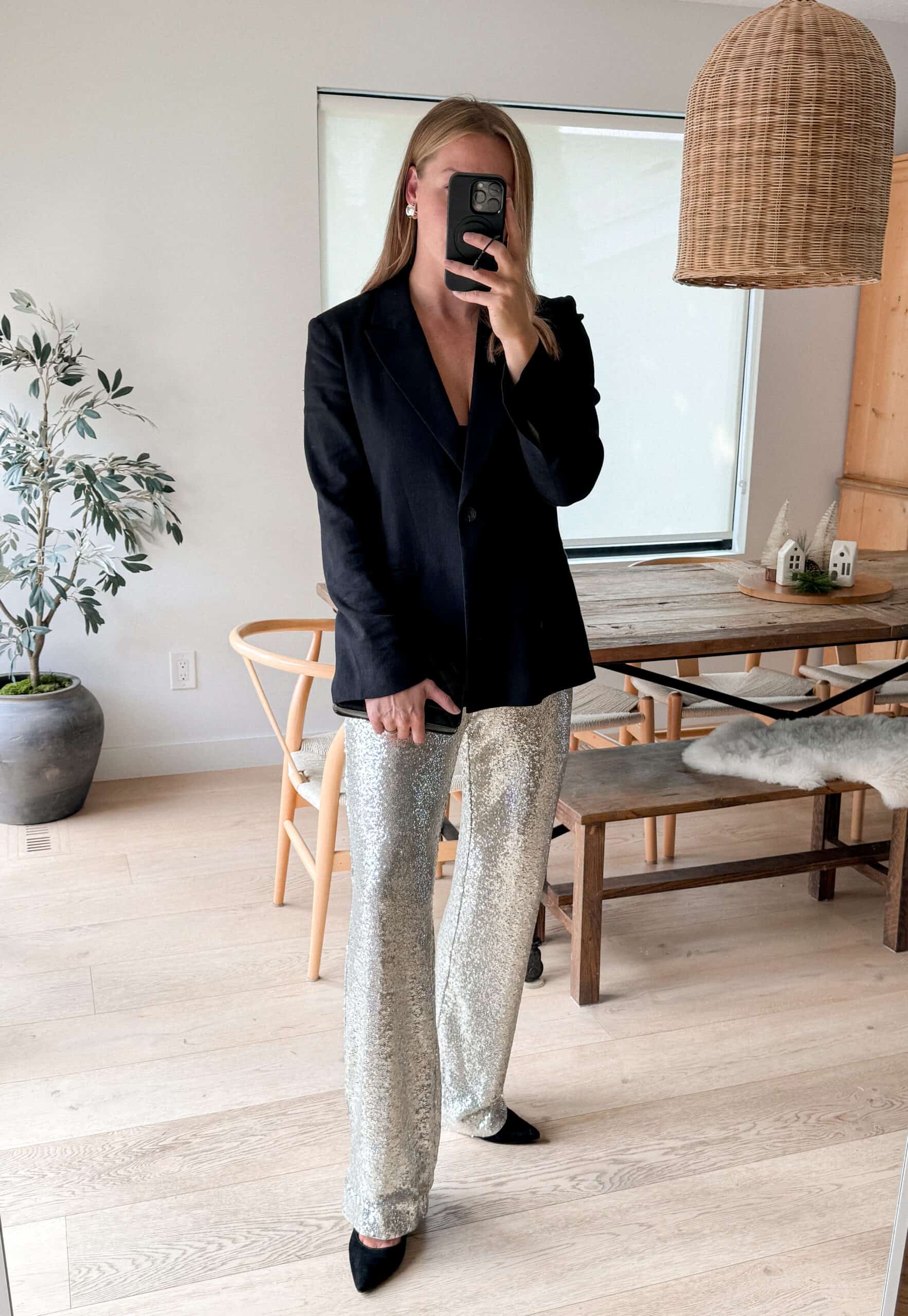 Christal wearing sequined pants with a black blazer and black pumps.