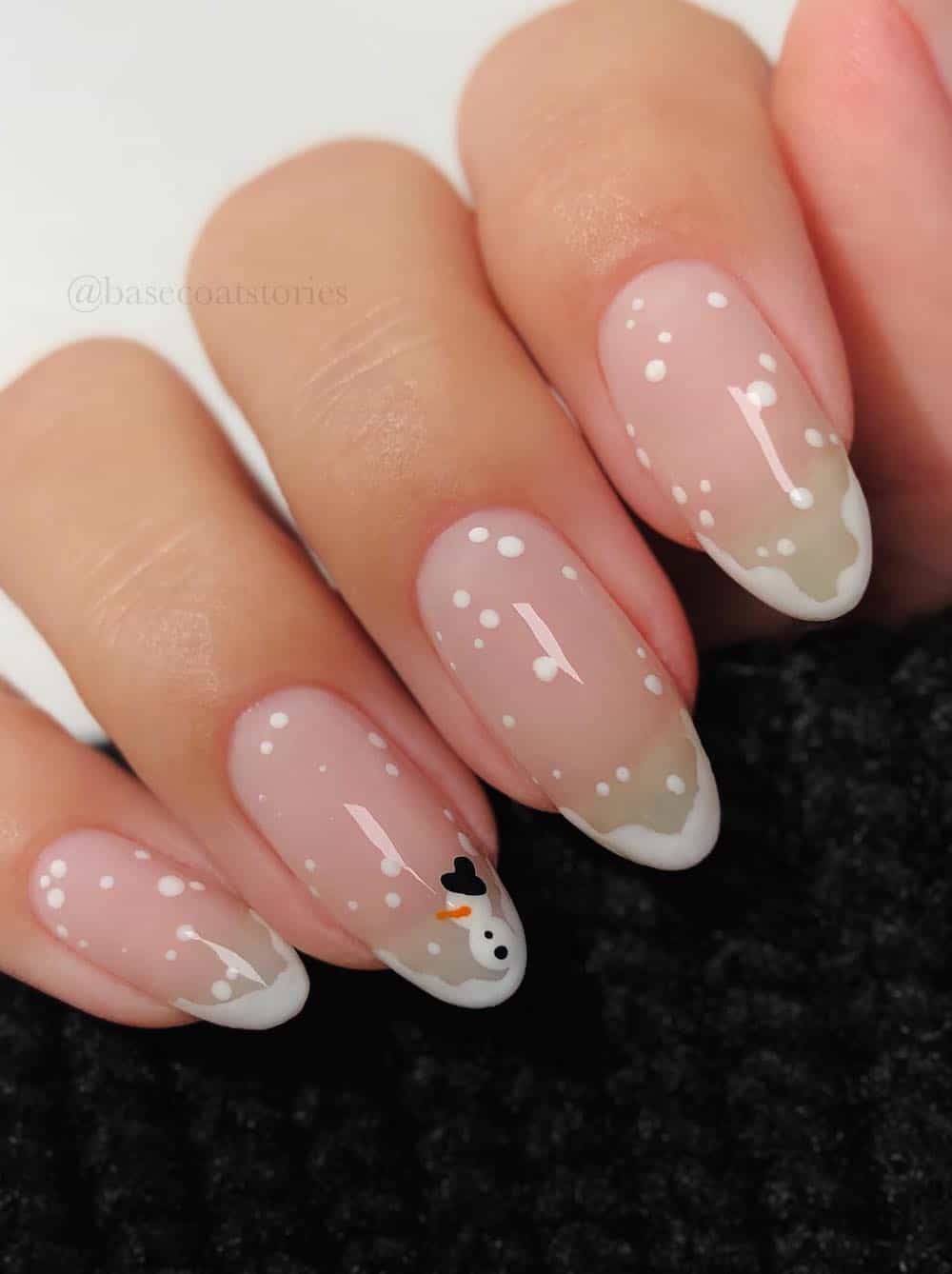 long glossy round nails with snowy french tips and a snowman accent